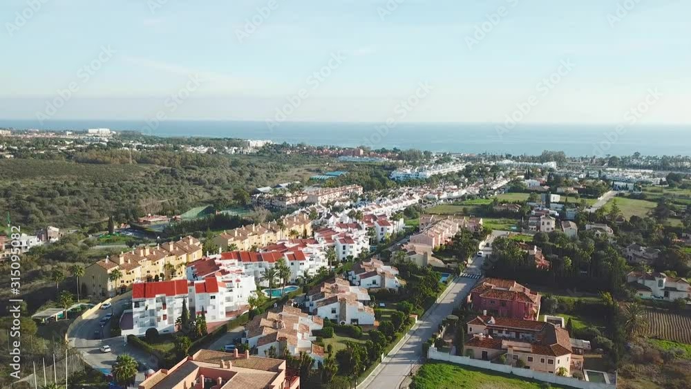 Aerial view of Luxury Urbanisation - Real Estate in famous area Bel-Air of Estepona. Mediterranean Sea in Background. Beautiful Andalusian Architecture.Down Aerial view of Luxury Urbanisation - Real Estate in famous area Bel-Air of Estepona. Mediterranean Sea in Background. Beautiful Andalusian Architecture.Down