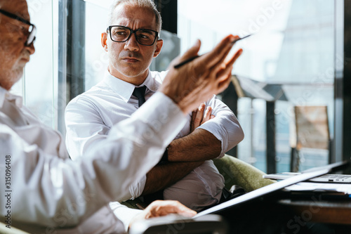 Corporate business team meeting discussion and startup concept. Successful businesspeople discussing together in conference room during meeting at modern business lounge high up in an office tower.