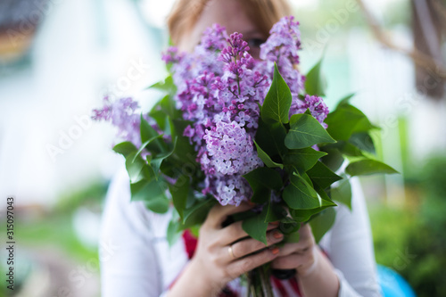 Happy woman with lilacs