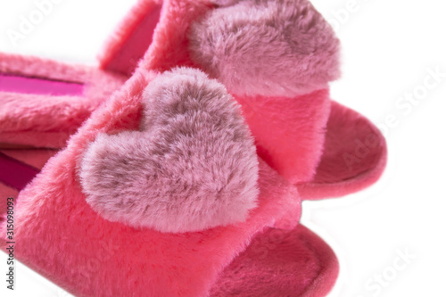 Pink home fluffy slippers on a white background