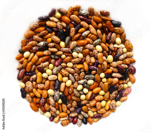 Beans dry mix. Assorted dried beans close up. Variety of protein rich colorful raw dried beans. Multicolored mixed dried beans on white background. Closeup, selective focus