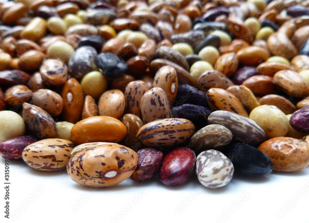Beans dry mix. Assorted dried beans close up. Variety of protein rich colorful raw dried beans. Multicolored mixed dried beans on white background. Closeup, selective focus Beans dry mix. Assorted dried beans close up. Variety of protein rich colorful raw dried beans. Multicolored mixed dried beans on white background. Closeup, selective focus