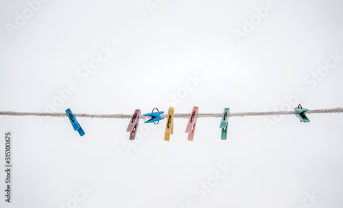 multicolored clothespins on a rope