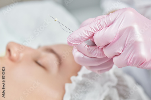 Photos Facial skin reinforcement in office of professional cosmetologist, facelift with