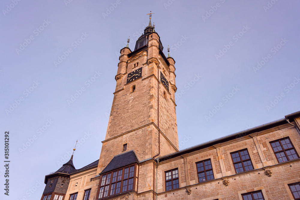 Germany, Saxony-Anhalt, Dessau-Rosslau: Facade of old city hall tower in late afternoon sunlight in the city center of the famous German town - concept administration government historic architecture