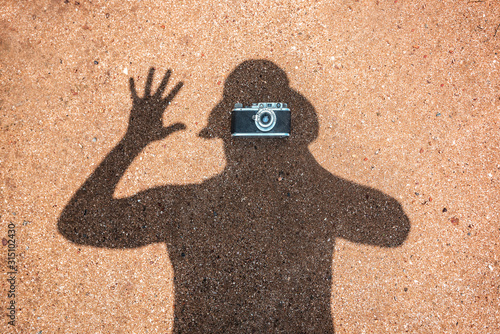 shadow on sand with vintage camera photo