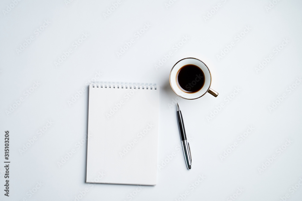 white office Desk top view with Notepad, pen and coffee Cup, minimalistic design,top view,copy space,flat lay white office Desk top view with Notepad, pen and coffee Cup, minimalistic design,top view,copy space,flat lay