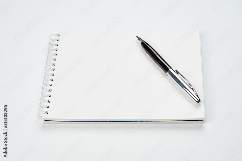 white office Desk top view with Notepad and pen,minimalistic design,top view,copy space,flat lay white office Desk top view with Notepad and pen,minimalistic design,top view,copy space,flat lay
