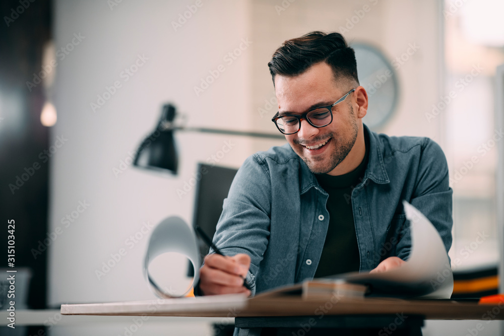 Young businessman working on project. Handsome architect in office. Young businessman working on project. Handsome architect in office.