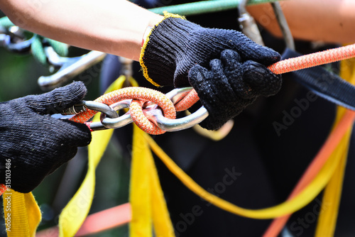 safety measures for rappelling and climbing, black protective gloves, rappel descent, safety equipment, rappelling safety equipment, adventure sport, rappel