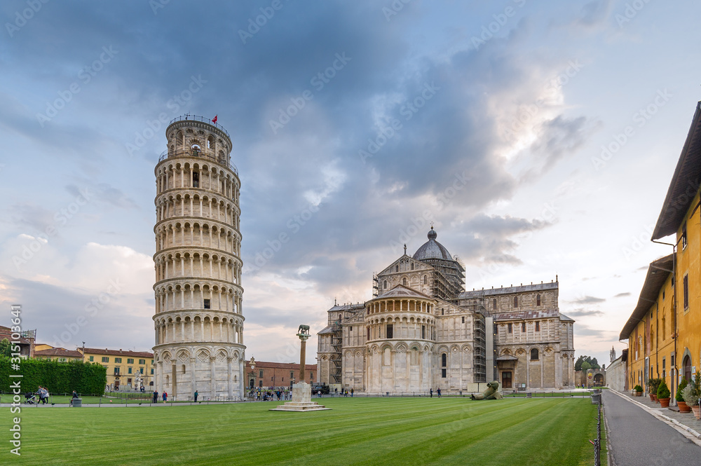 Evening light an Pisa center, view of most famous attractions, Duomo cathedral and tilting tower. Pisa, Italy,