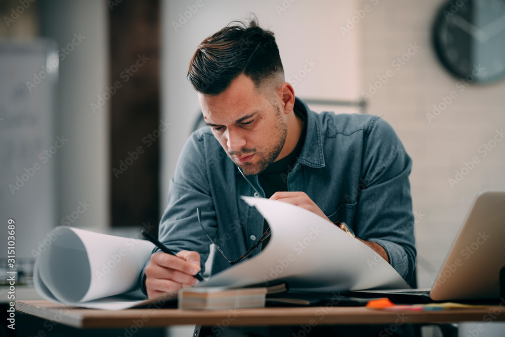 Young businessman working on project. Handsome architect in office. Young businessman working on project. Handsome architect in office.