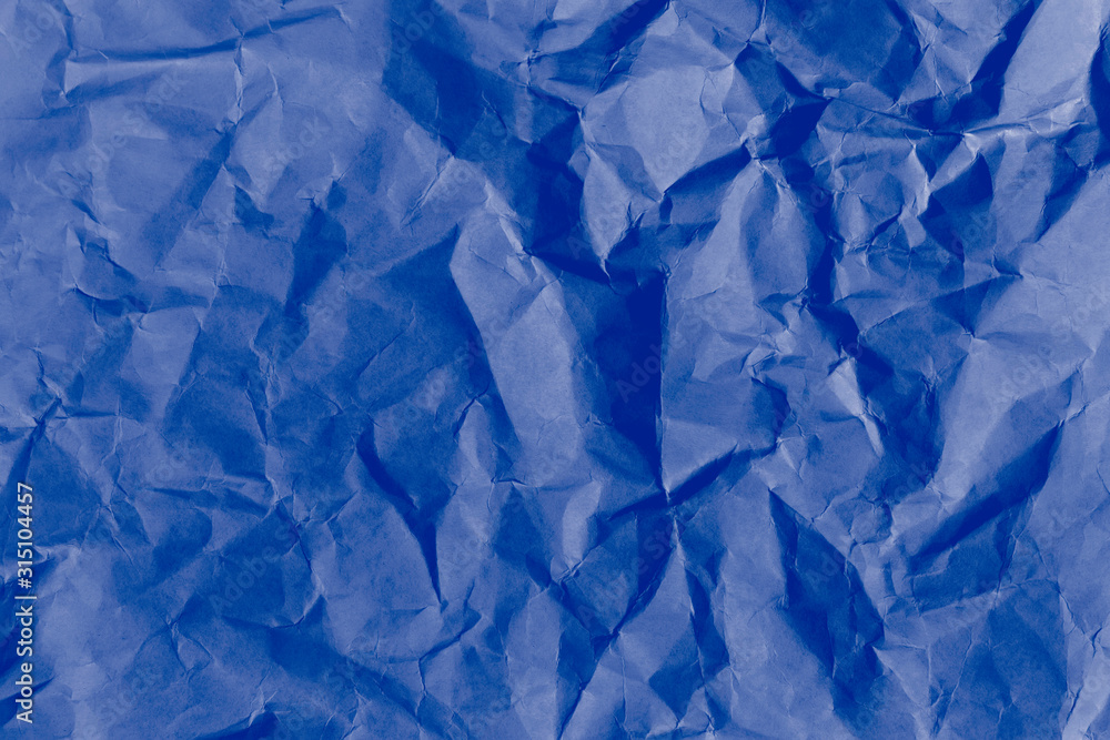 Picture of the blank dark blue crumpled and creased paper, poster texture background with copy space Picture of the blank dark blue crumpled and creased paper, poster texture background with copy space