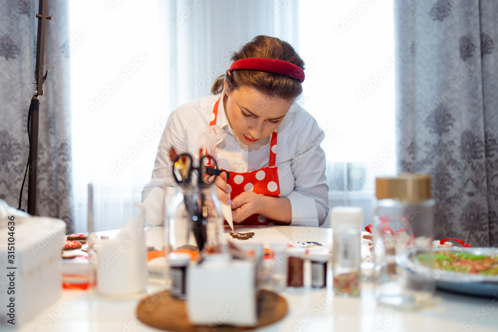 A young housewife makes cookies to celebrate A young housewife makes cookies to celebrate