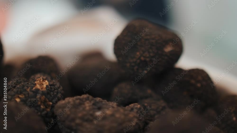 Close Up View Over Black Truffles In A Bowl. Rack Focus Close Up View Over Black Truffles In A Bowl. Rack Focus