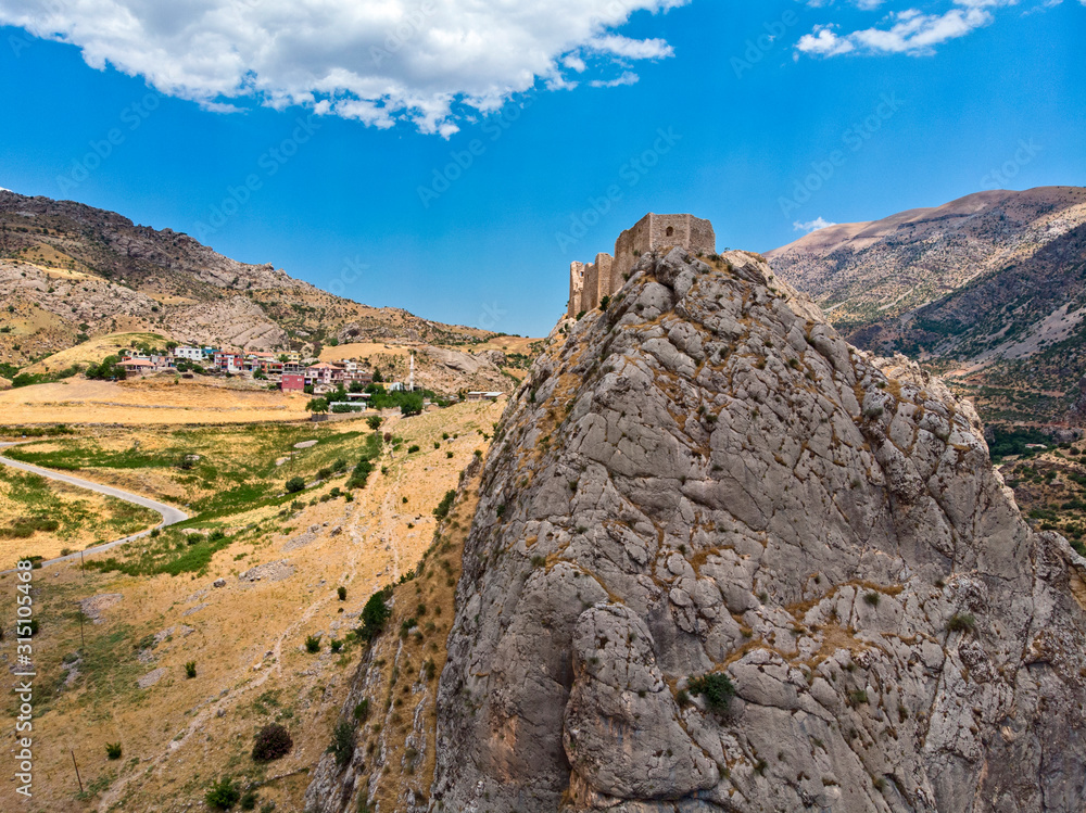 Aerial view of Kahta Castle, Kalesi. The Yeni Kale Fortress in Eski Kahta is perched atop a hill with a steep slope. Walls of the manor surround the entire hill. Very close to Mount Nemrut. Anatolia. 