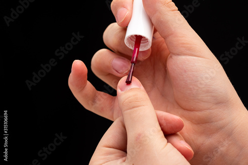 female hands hold nail polish and are going to do manicure