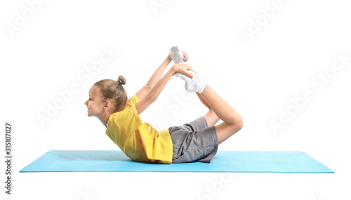 Little girl practicing yoga...