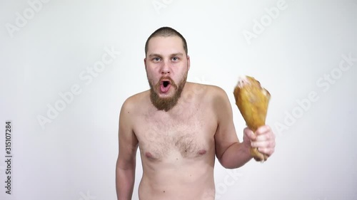 Primitive man dancing with fried chicken leg .Neanderthal, crazy,mad,monkey. photo