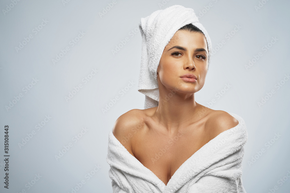 Woman posing in bathrobe after shower. Woman posing in bathrobe after shower.