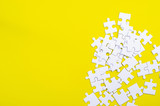 White jigsaw puzzle on a yellow background
