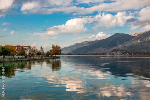 View of lake Pamvotis and the waterfront of the city of Ioannina, in Epirus, Greece, on a sunny winter afternoon.
