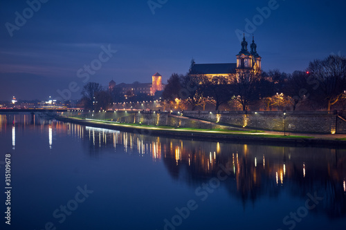 Night city landscape. The Vistula River at night in Krakow, Poland.