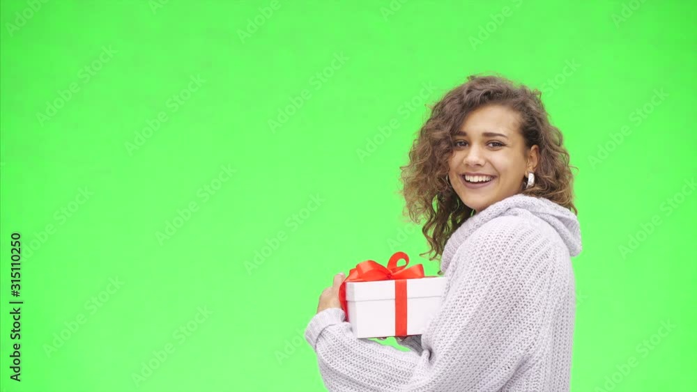 Afro-American woman is recieving a giftbox with red ribbon. Best wishes. Close up. Copy space. Afro-American woman is recieving a giftbox with red ribbon. Best wishes. Close up. Copy space.