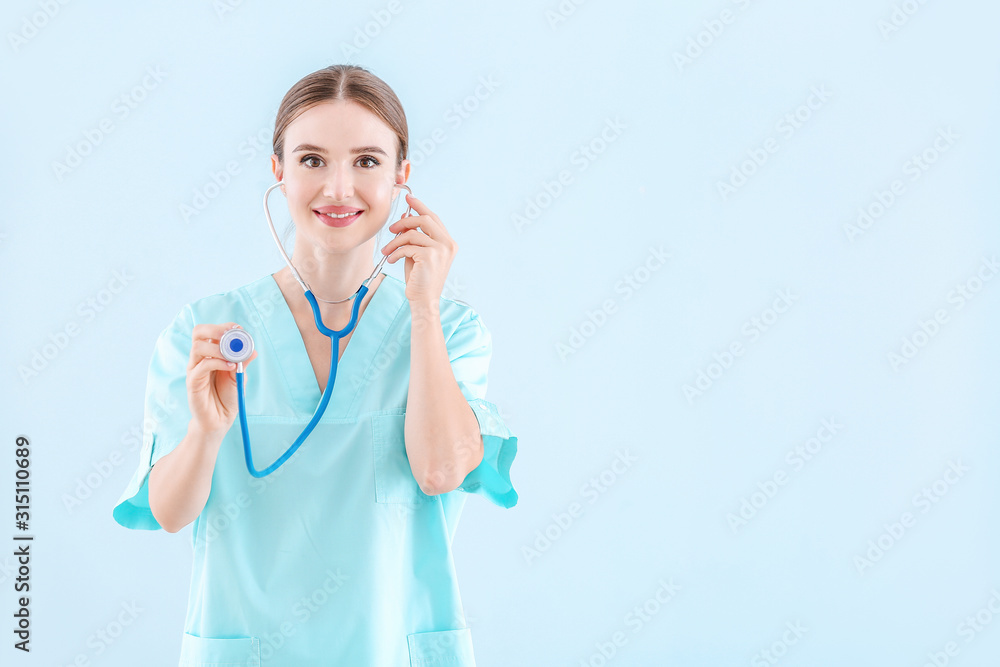 Portrait of female doctor with stethoscope on light background Portrait of female doctor with stethoscope on light background
