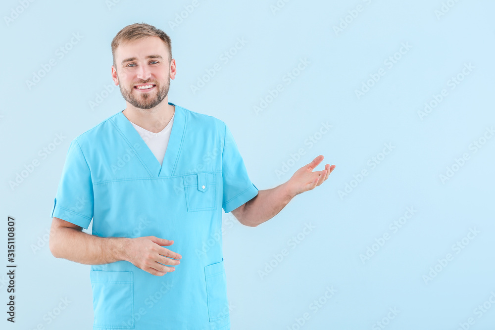 Portrait of male doctor showing something on light background Portrait of male doctor showing something on light background