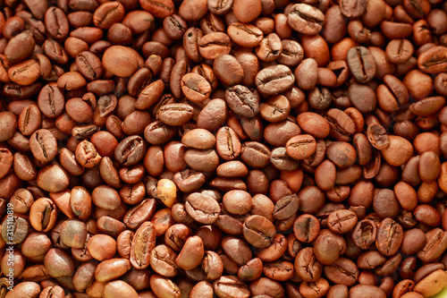 Roasted coffee beans background. Coffee beans texture. Arabica and Robusta in the morning for the coffee machine. Refreshment in the morning © Miglena
