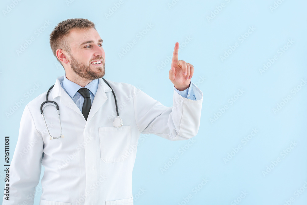 Portrait of male doctor showing something on light background Portrait of male doctor showing something on light background