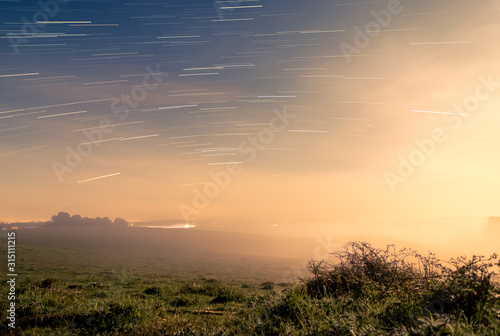 Meteor shower over tranquil landscape, Naestved, Denmark photo