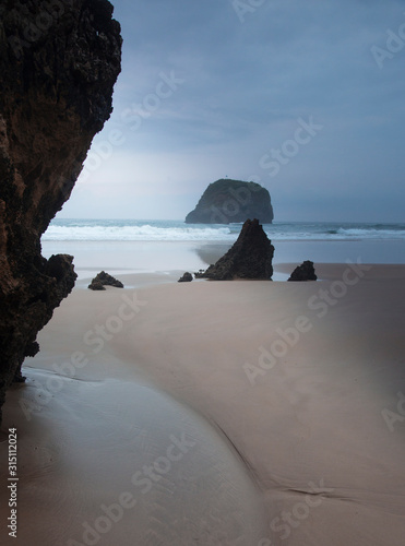 Rocks on tranquil ocean beach Borizo Beach Asturias Spain photo