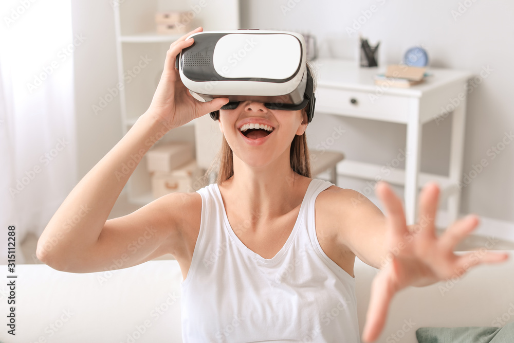 Young woman with virtual reality glasses at home Young woman with virtual reality glasses at home