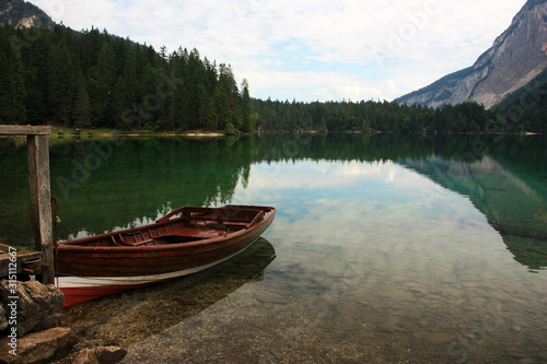 Wooden boat at the pier of the lake