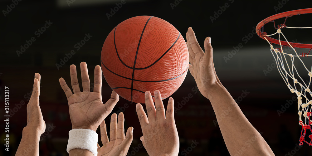 Basketball ball is flying with basketball hoop over a basketball court