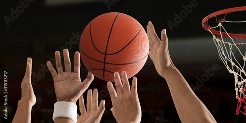 Fototapeta Basketball ball is flying with basketball hoop over a basketball court