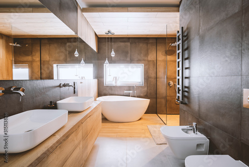 Stampa su tela Stylish bathroom with wooden and concrete walls and white bath