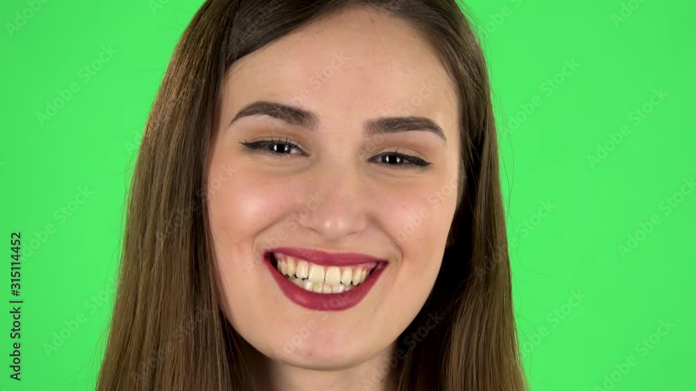Cheery female bursting with laughter being in positive over green screen. Close up. Cheery female bursting with laughter being in positive over green screen. Close up.