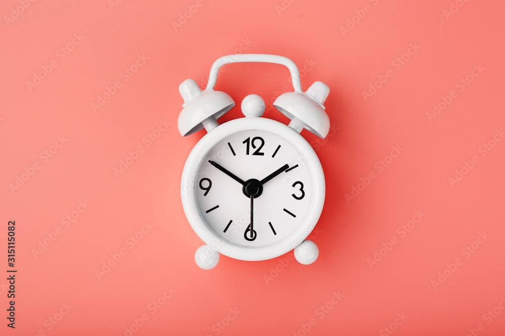 White retro alarm clock on pink background. Concept of time with free space for text. White retro alarm clock on pink background. Concept of time with free space for text.