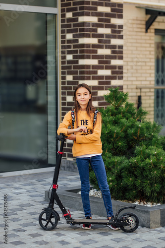 A young child girl riding in a city park on a gyroscooter. © Тарас Нагирняк