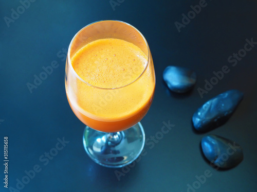 A glass of healthy carrot juice on the table photo