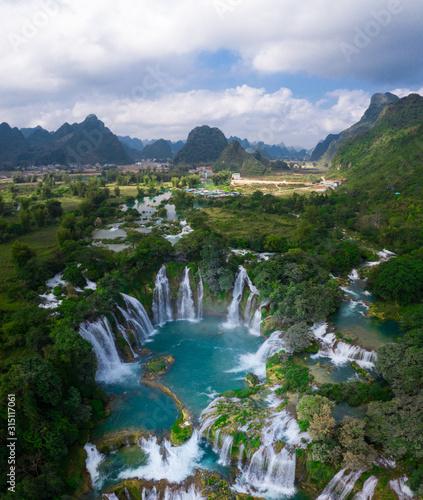 Massive hidden waterfall surrounded by mountain with blue clean water. Paradise on the border between China and Vietnam. Ban gioc waterfall, Detian.