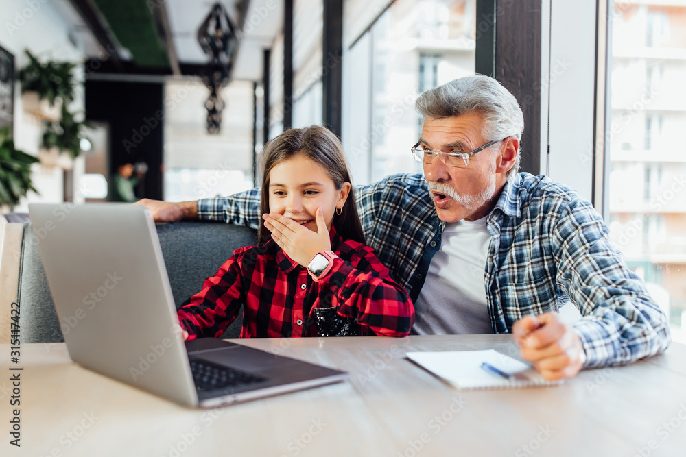 Old man with his granddaughter using tablet making video call to child. Old man with his granddaughter using tablet making video call to child.
