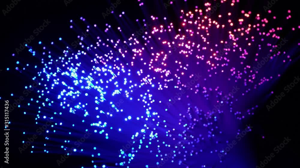 Fiber optics wire lamp, in the dark, with blurry bokeh, a symbol of high technology in online communication. Fiber optics wire lamp, in the dark, with blurry bokeh, a symbol of high technology in online communication.
