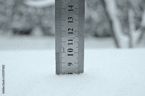 photo with a centimeter ruler as an indicator of snow depth