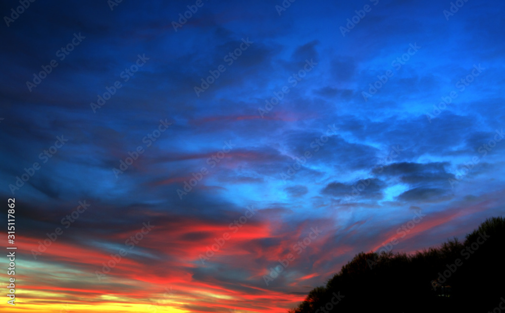 Colorful sunset sky with big clouds. Nature background.