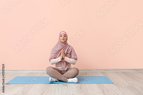 Sporty Muslim woman practic...