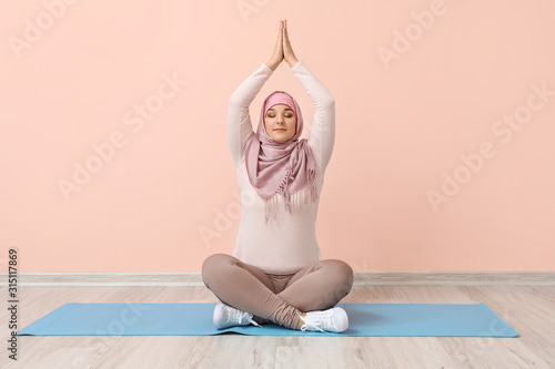 Sporty Muslim woman practic...